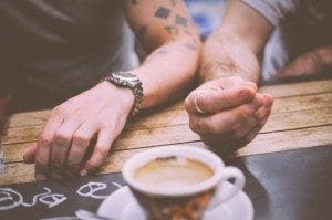 two men hands with coffee