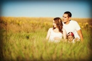 family sitting in a field