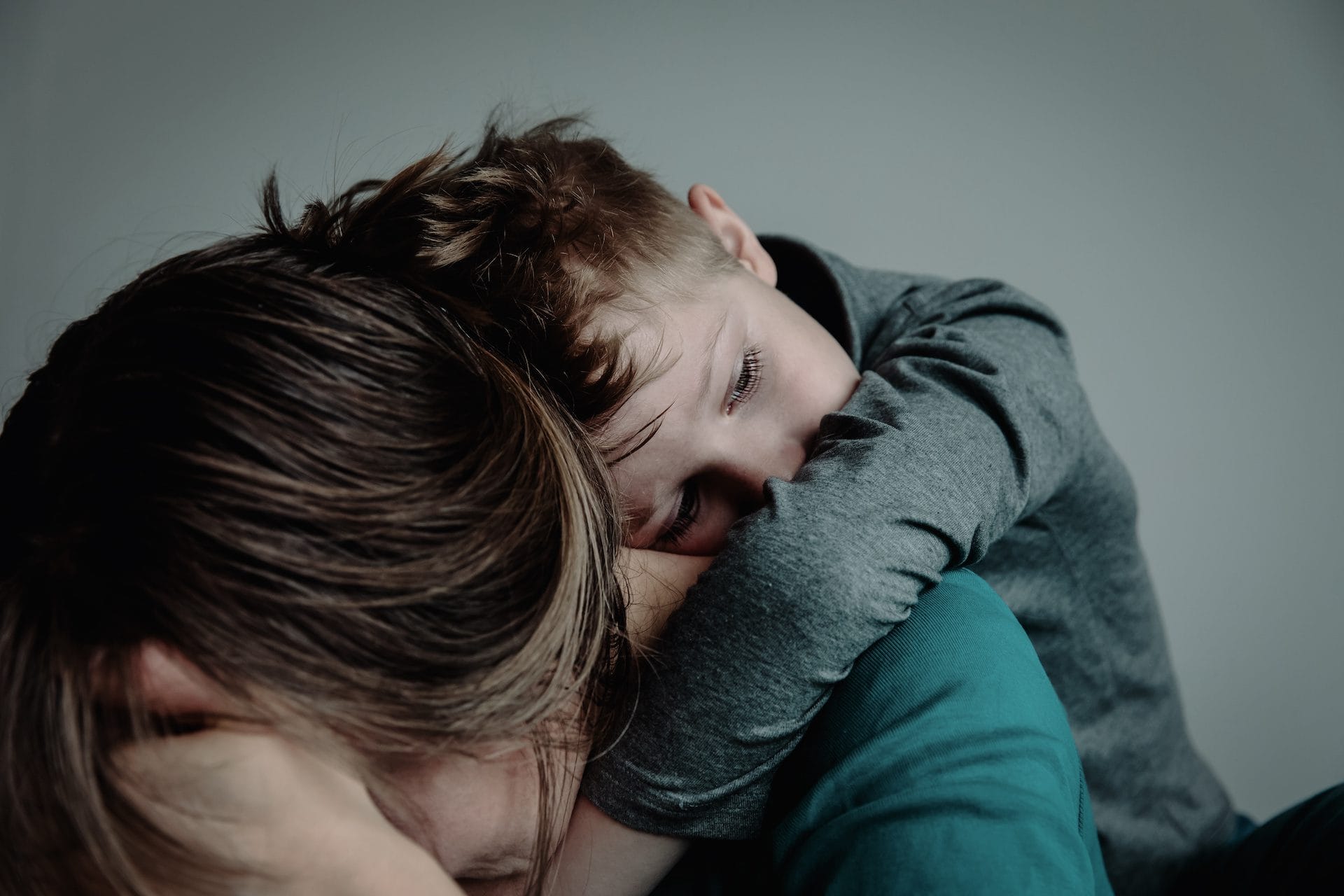 sad child with mother, family in sorrow