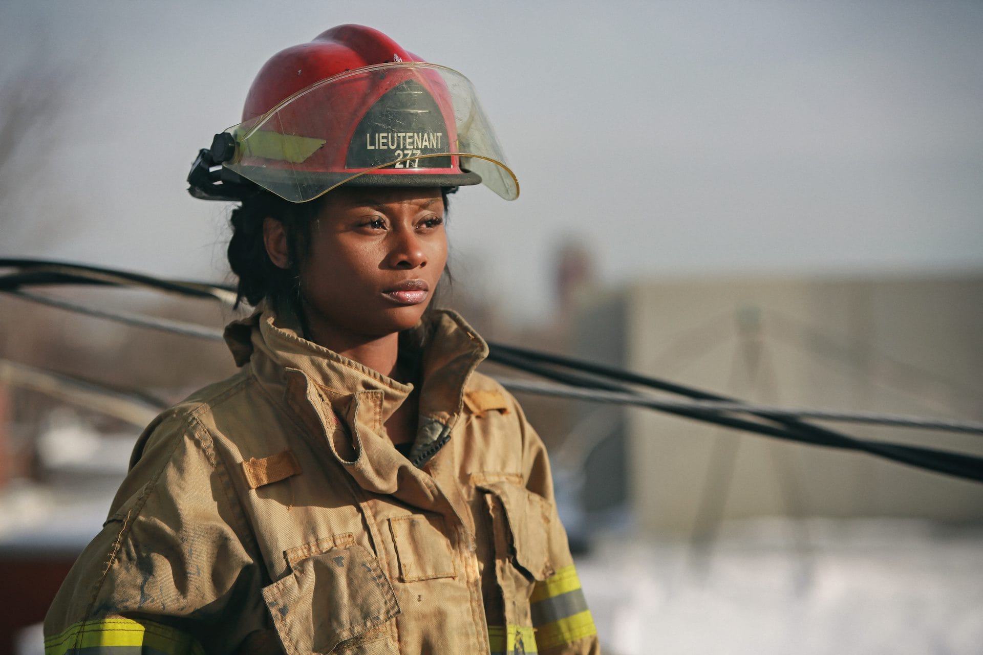 Women Firefighter with red helmet standing outside