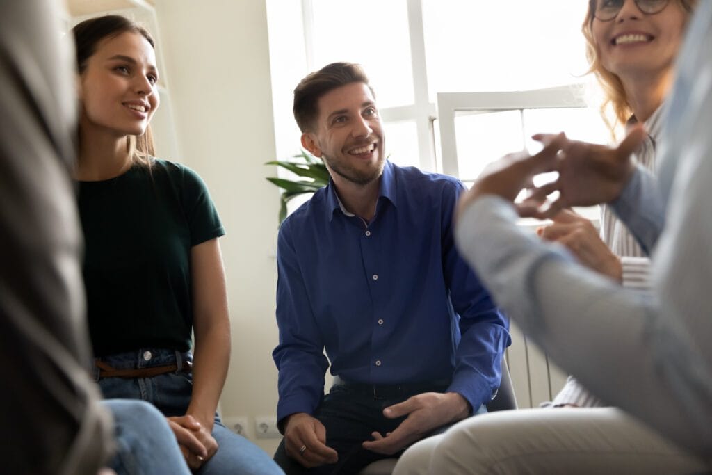 Diverse people attending at group therapy session listening psychologist counsellor