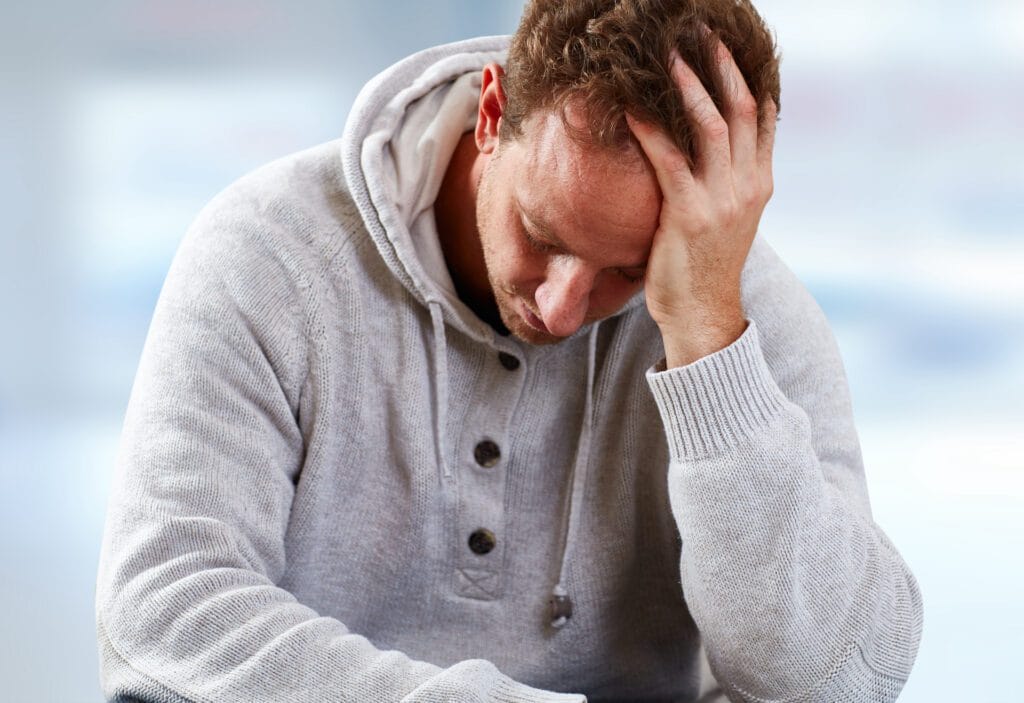 Depressed man having a headache