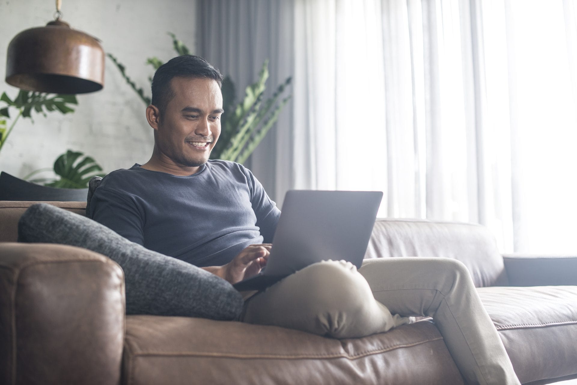 Man looking at the computer at home.