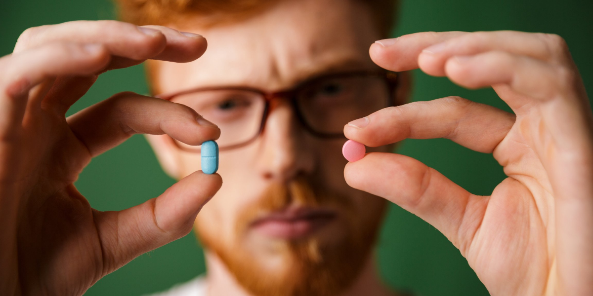 man with a blue and red pill