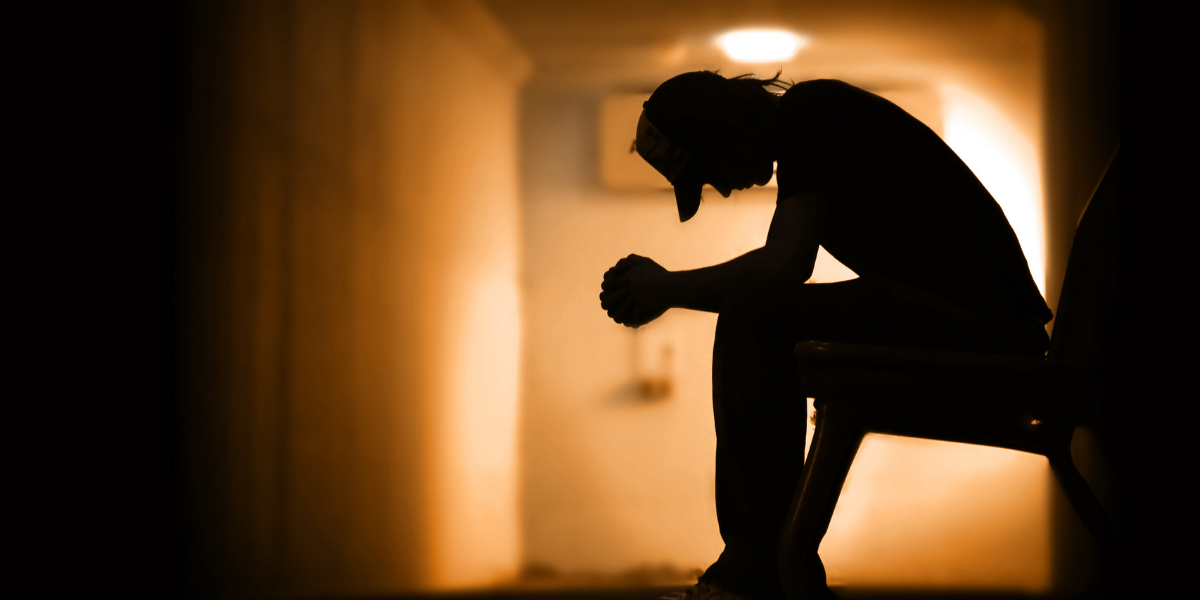 man sitting in the hallways down and depressed