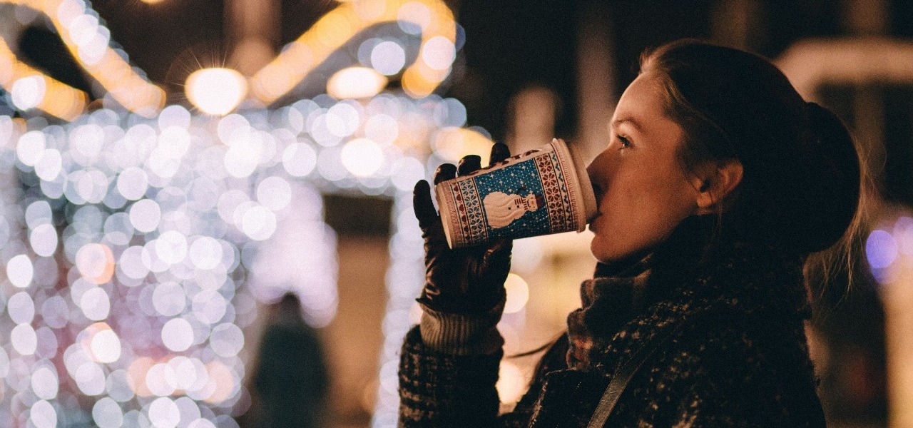 Woman drinking coffee on christmas night