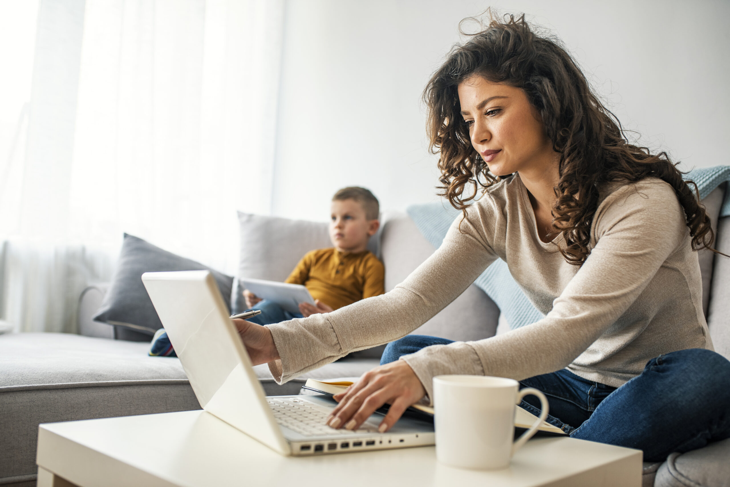 Woman working at home while child is there