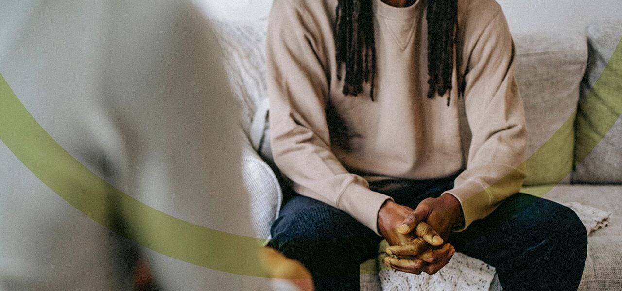 man clasping hands during his therapy session