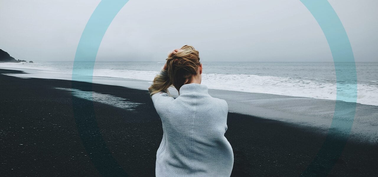 A woman alone at the beach as she struggles with drug abuse