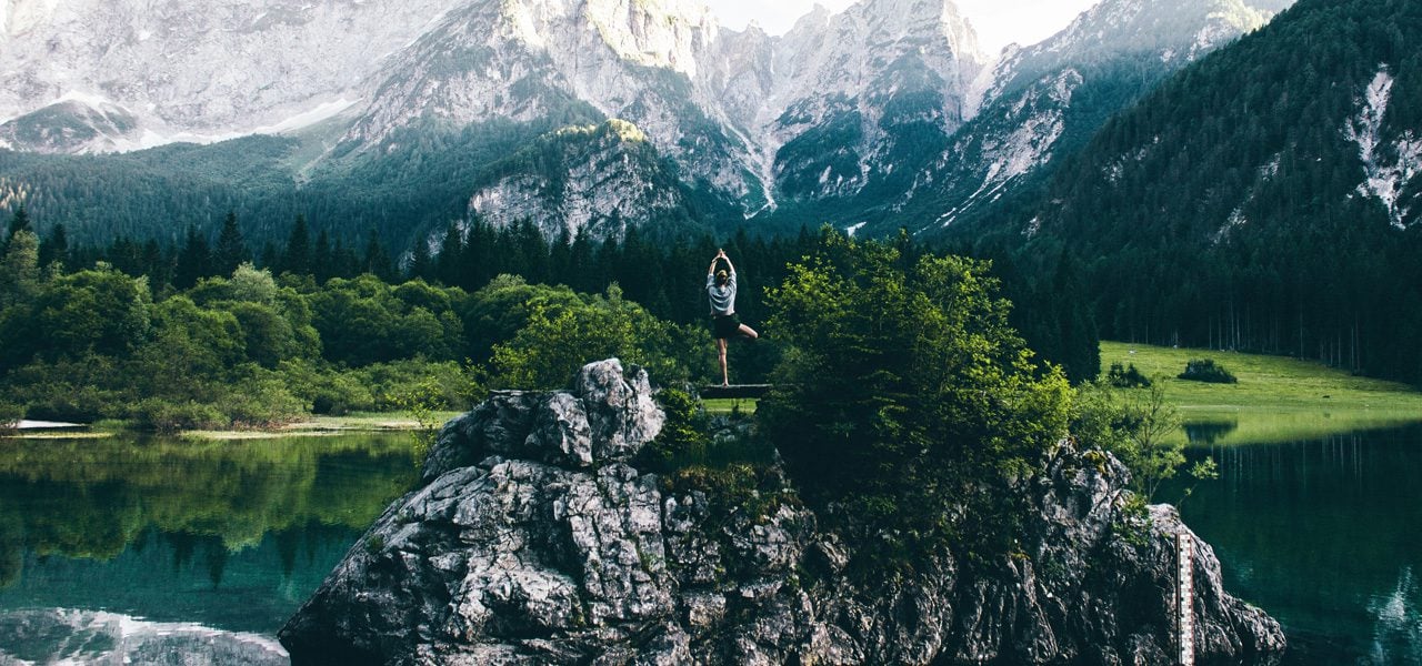Woman practicing yoga in the mountains.