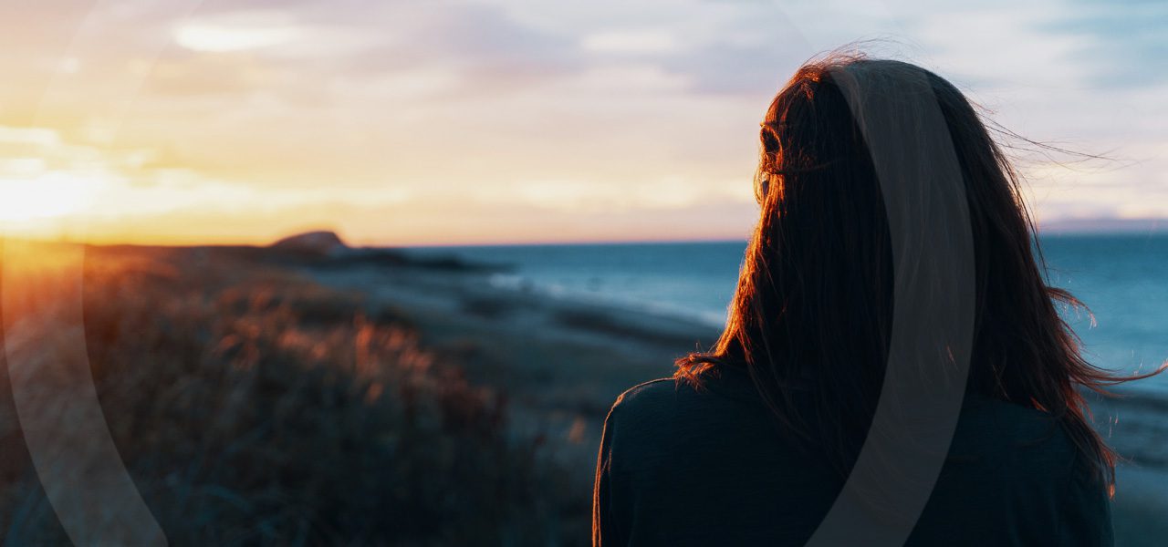woman looking at sunset
