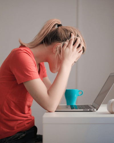 woman with hands on her head