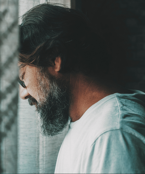 man with head on a wall